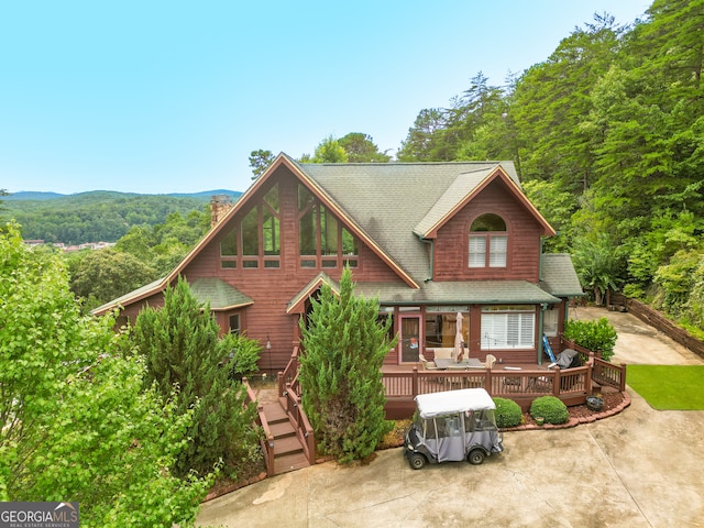 view of front of home featuring a deck with mountain view