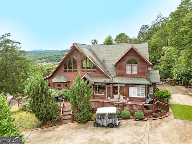 view of front of home with a deck with mountain view