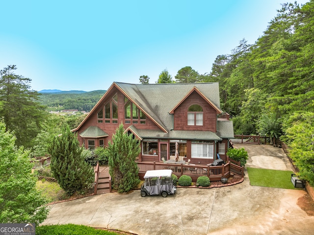 view of front of home with a deck with mountain view