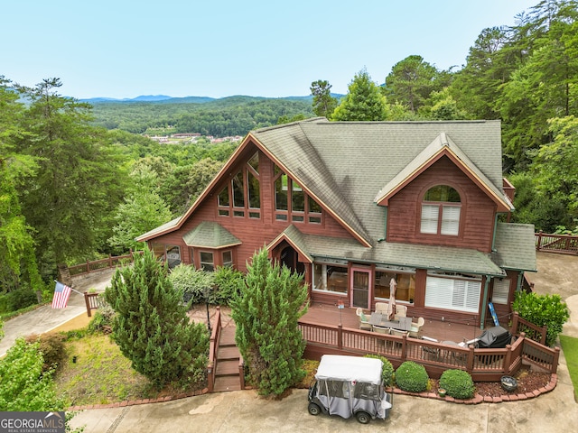 exterior space featuring a deck with mountain view