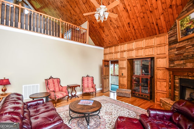 living room featuring wood-type flooring, high vaulted ceiling, and wooden ceiling