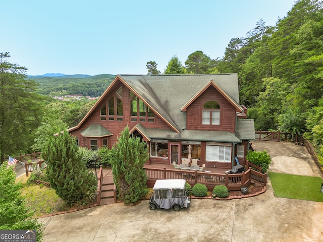 view of front facade featuring a deck with mountain view