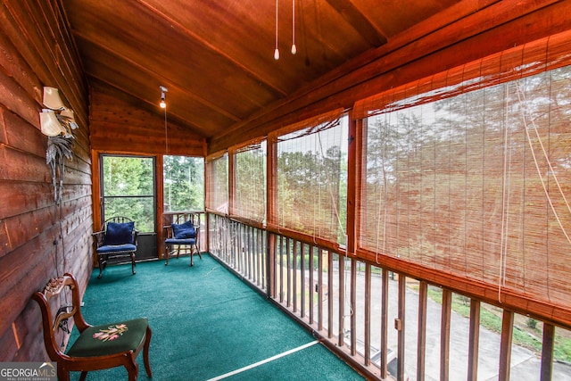 unfurnished sunroom featuring vaulted ceiling and wood ceiling