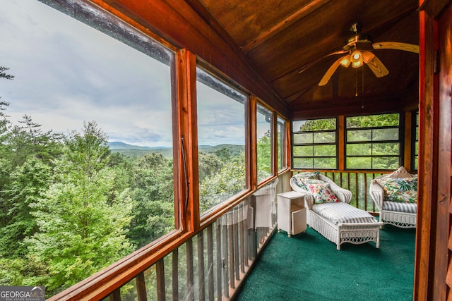 unfurnished sunroom featuring wood ceiling, ceiling fan, and vaulted ceiling