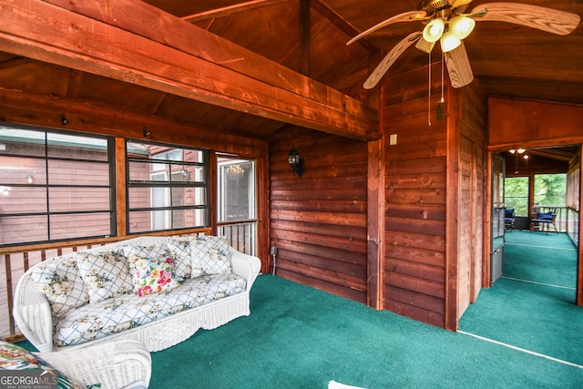 unfurnished room featuring lofted ceiling with beams, carpet flooring, wood ceiling, and ceiling fan