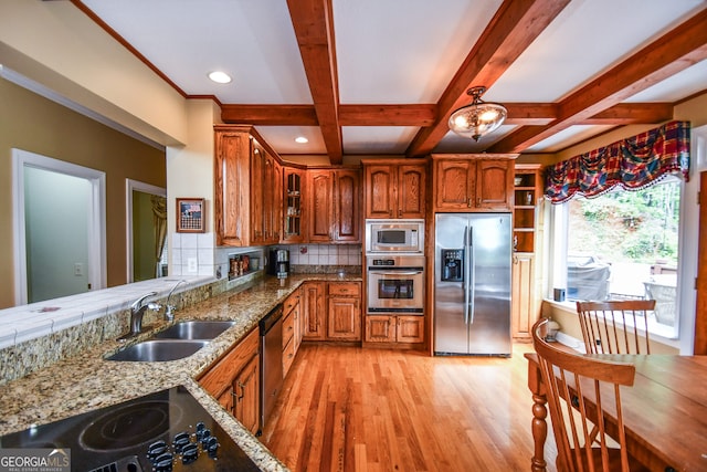 kitchen with sink, light wood-type flooring, decorative backsplash, stainless steel appliances, and beam ceiling