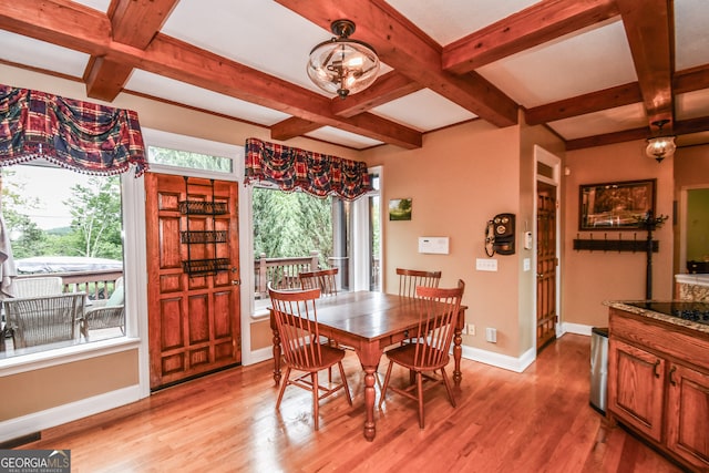 dining area featuring plenty of natural light, coffered ceiling, and light hardwood / wood-style flooring