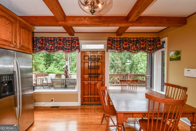 dining area featuring beamed ceiling, coffered ceiling, and light wood-type flooring