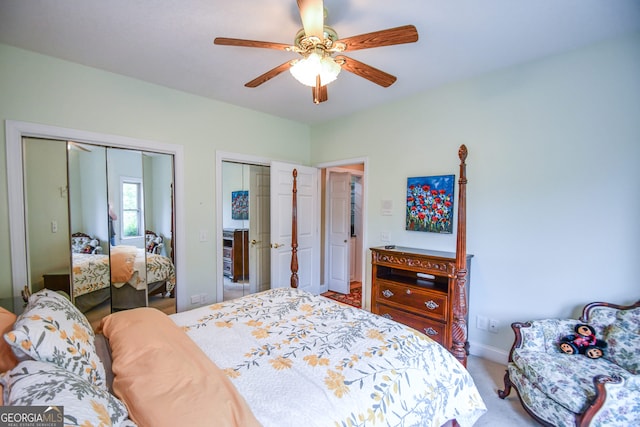 bedroom featuring two closets, ceiling fan, and carpet flooring