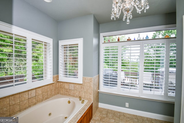 bathroom with a relaxing tiled tub and a chandelier