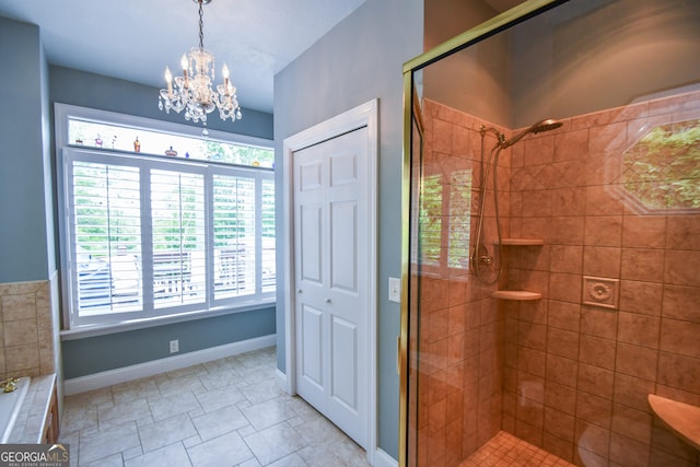 bathroom featuring an inviting chandelier and independent shower and bath