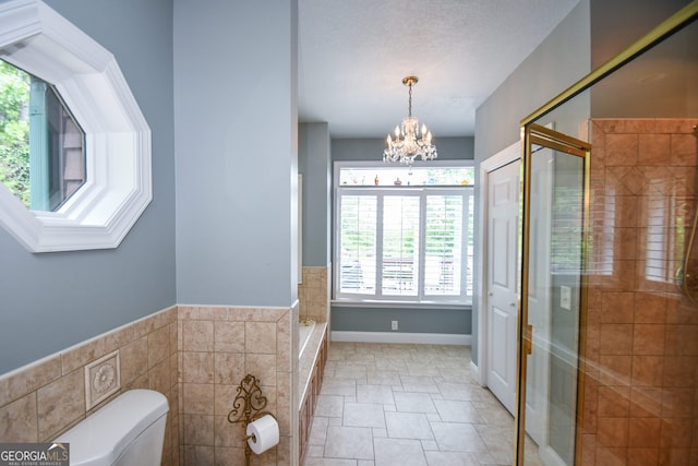 bathroom featuring toilet, an enclosed shower, a chandelier, tile walls, and a textured ceiling