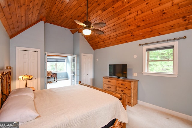 carpeted bedroom with multiple closets, vaulted ceiling, wood ceiling, and multiple windows