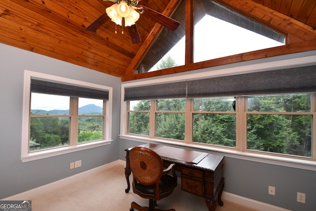 carpeted home office with wood ceiling, ceiling fan, a mountain view, and vaulted ceiling