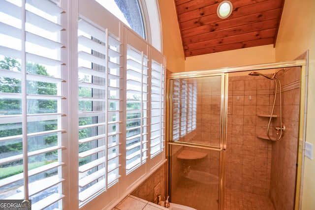 bathroom with a shower with door, vaulted ceiling, and wooden ceiling