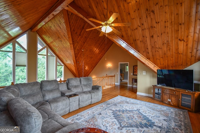 living room featuring vaulted ceiling with beams, wood ceiling, light hardwood / wood-style floors, and ceiling fan