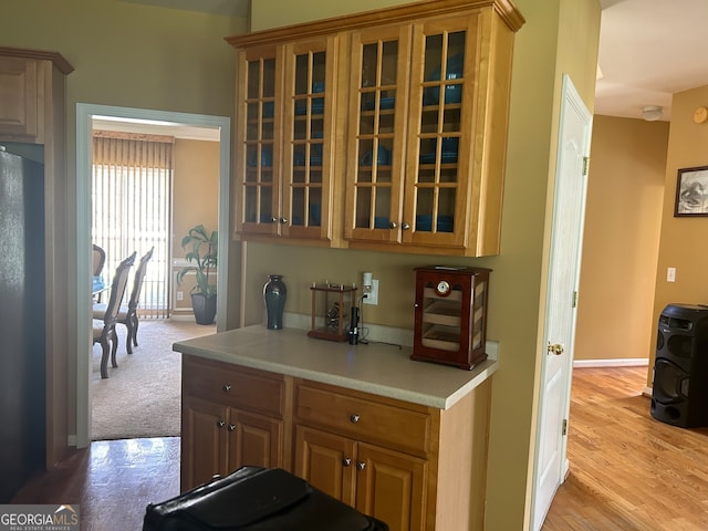 kitchen with light carpet and stainless steel refrigerator