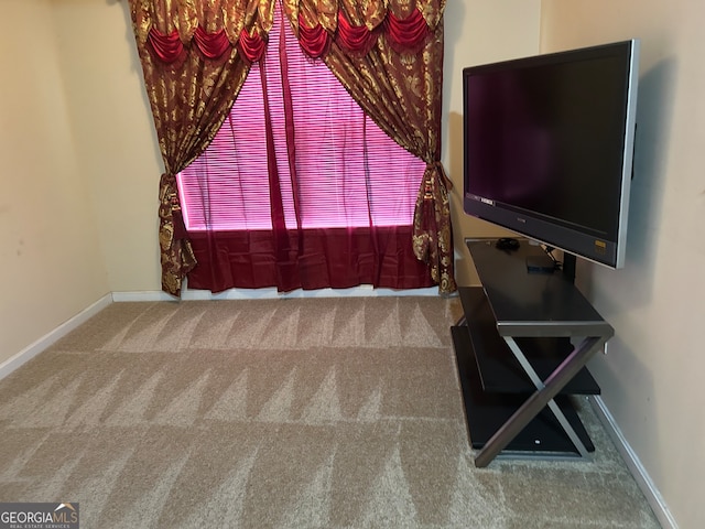 unfurnished living room featuring a notable chandelier and carpet