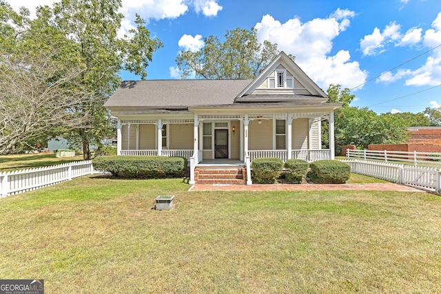 view of front of home with covered porch and a front yard