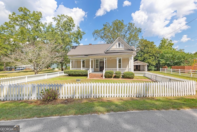 view of front of home featuring covered porch and a front yard