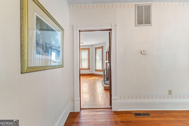 hallway with hardwood / wood-style floors