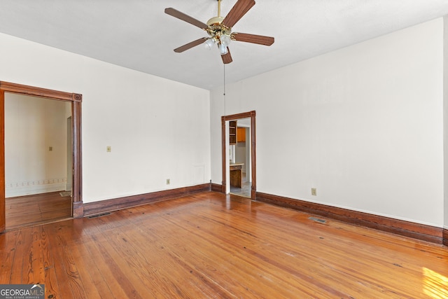 unfurnished room with ceiling fan and hardwood / wood-style floors