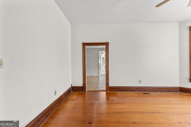 spare room with hardwood / wood-style flooring and ceiling fan