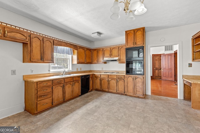 kitchen with sink, a textured ceiling, black appliances, and a notable chandelier