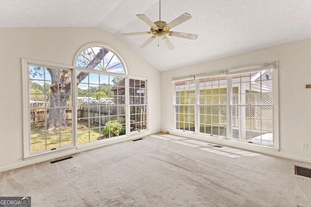 unfurnished sunroom featuring lofted ceiling and ceiling fan