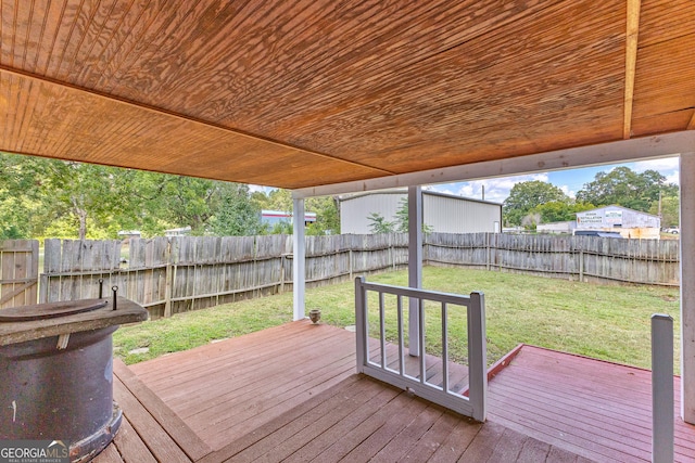 wooden deck featuring a lawn