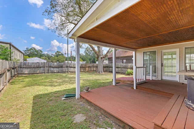 wooden deck with a lawn