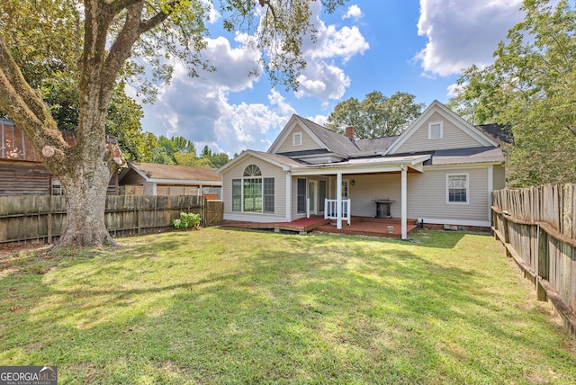 back of house featuring a yard and a wooden deck