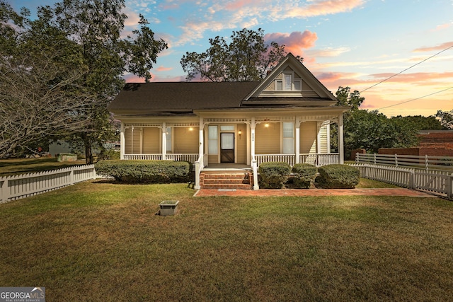 view of front of home featuring a porch and a lawn