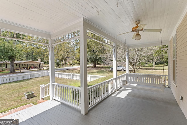 exterior space with a porch, ceiling fan, and a yard