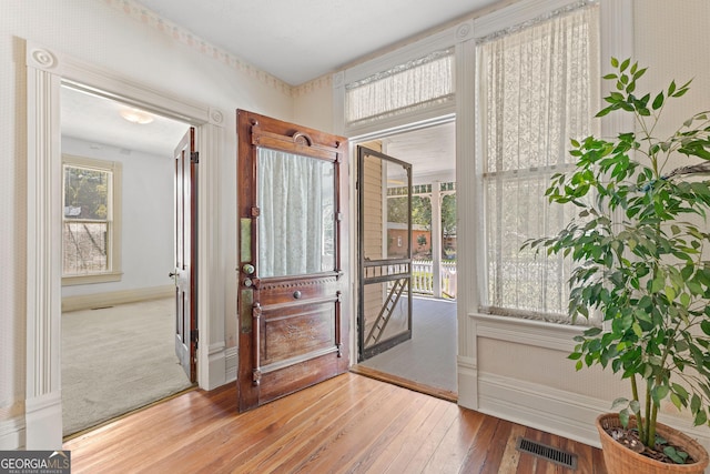 entryway with light wood-type flooring and a wealth of natural light