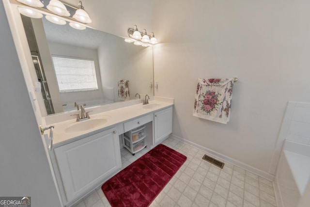 bathroom featuring a washtub and vanity