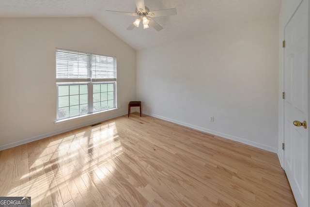 unfurnished room featuring vaulted ceiling, ceiling fan, and light hardwood / wood-style flooring