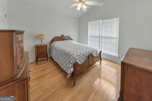 bedroom featuring vaulted ceiling, light hardwood / wood-style floors, and ceiling fan