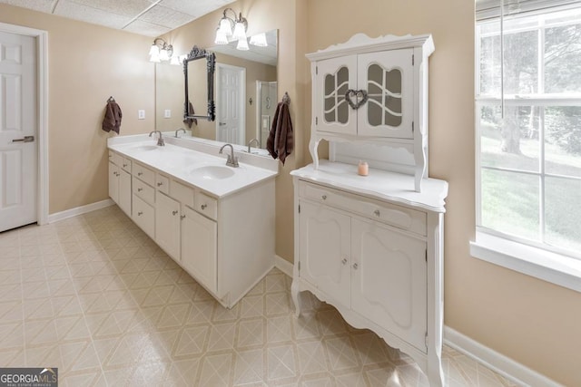 bathroom featuring vanity and a drop ceiling