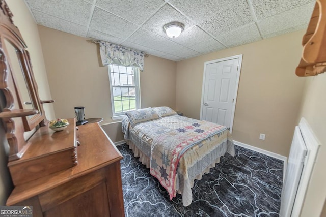 bedroom with a paneled ceiling