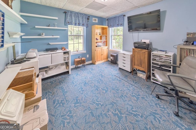 office area with dark colored carpet and a drop ceiling