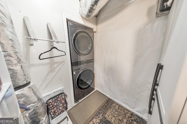 laundry area featuring stacked washer / dryer