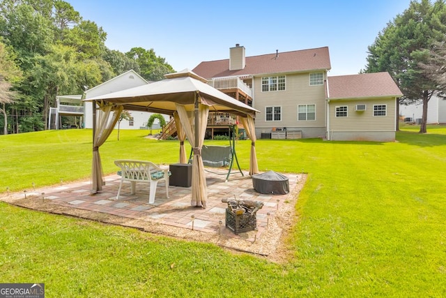 exterior space featuring a gazebo, an outdoor fire pit, a patio area, and a lawn