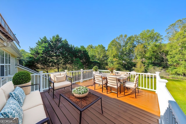 wooden deck featuring a yard and outdoor lounge area