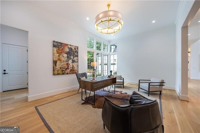 office space with light wood-type flooring and crown molding