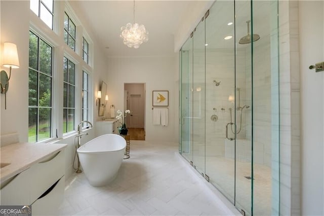 bathroom with independent shower and bath, vanity, tile patterned flooring, and a chandelier