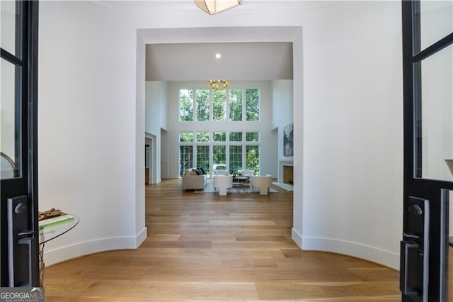 foyer with light hardwood / wood-style flooring and a chandelier