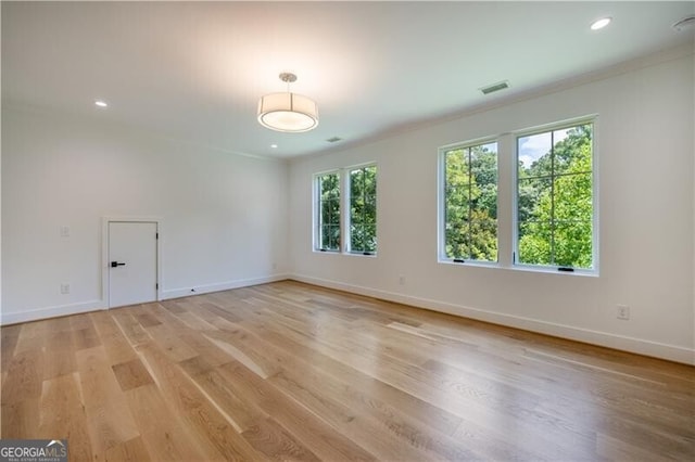 empty room with light hardwood / wood-style floors