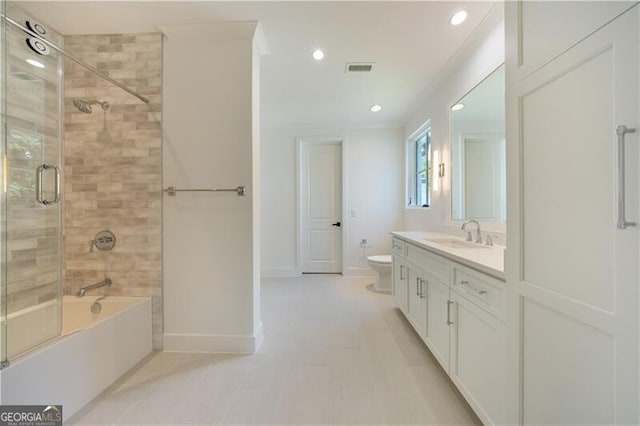 full bathroom featuring toilet, combined bath / shower with glass door, ornamental molding, and vanity