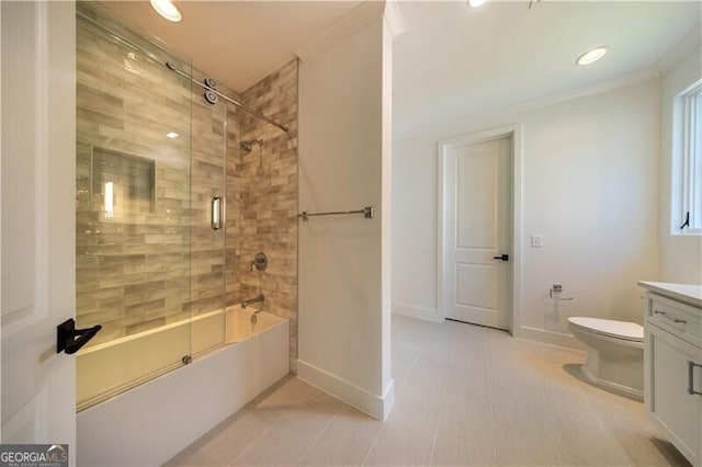 full bathroom with shower / bath combination with glass door, toilet, crown molding, and vanity